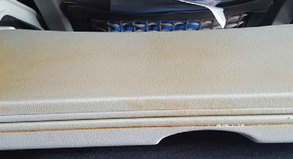 Image: Competitor seat back tray, stained